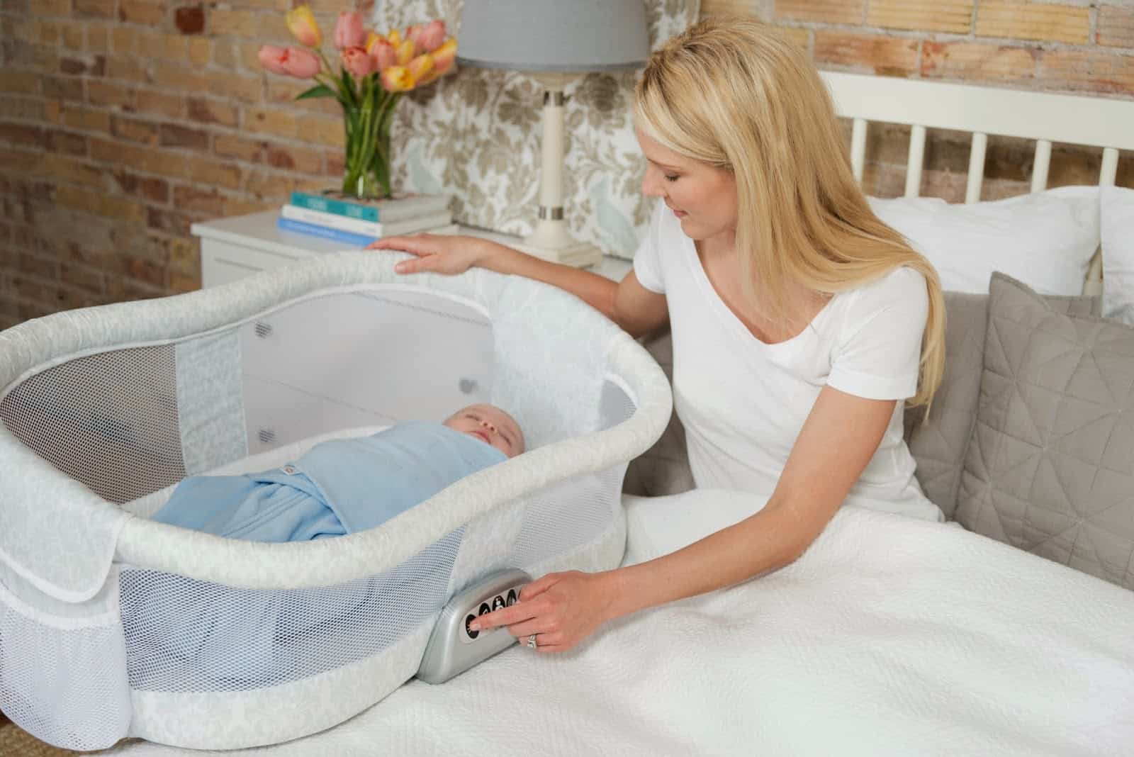 baby in a bassinet with mother