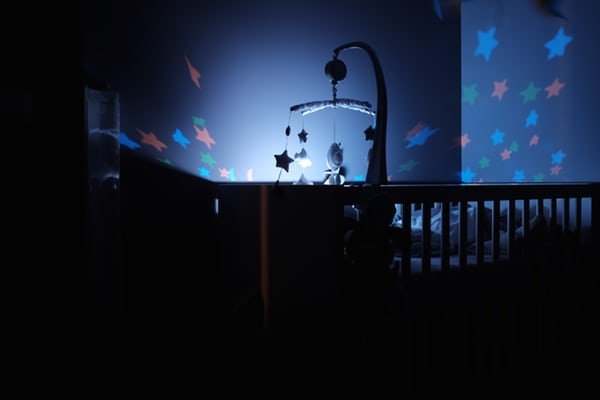 baby crib with toys at night