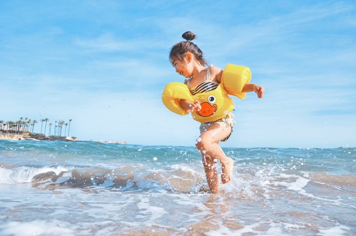 girl floats beach